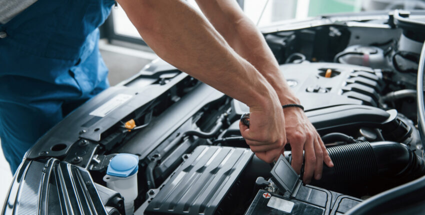 Mechanic inspecting engine for faults