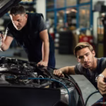 Mechanics performing vehicle repairs